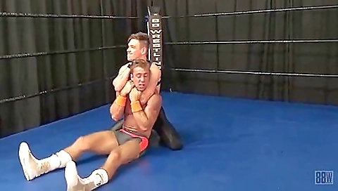 A hardcore gay dude is playing with a big cock in his wrestling ring