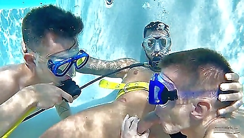 Two men work with each other in the water in a deep-sea threesome