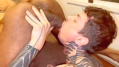 Tattooed brunette with big dick on bed in deepthroat pov